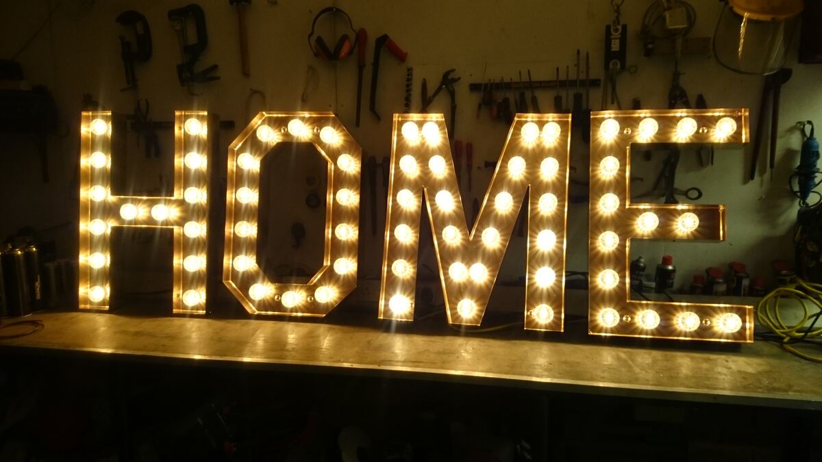 HOME spelled out in glowing marquee letters