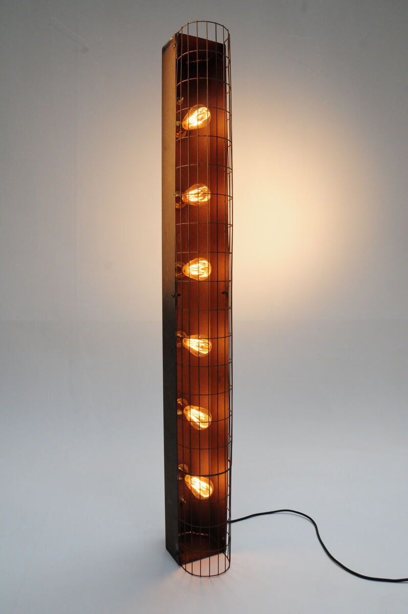 Slim steel column lamp with a vertical row of filament bulbs