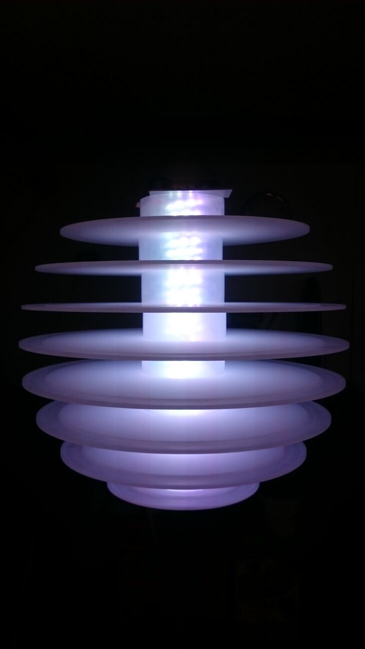 Tiered white discs glowing softly against a dark background